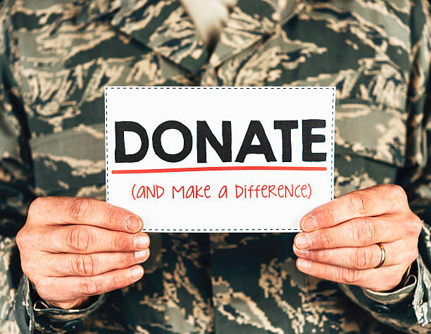 Veteran holding a Donate and make a difference sign