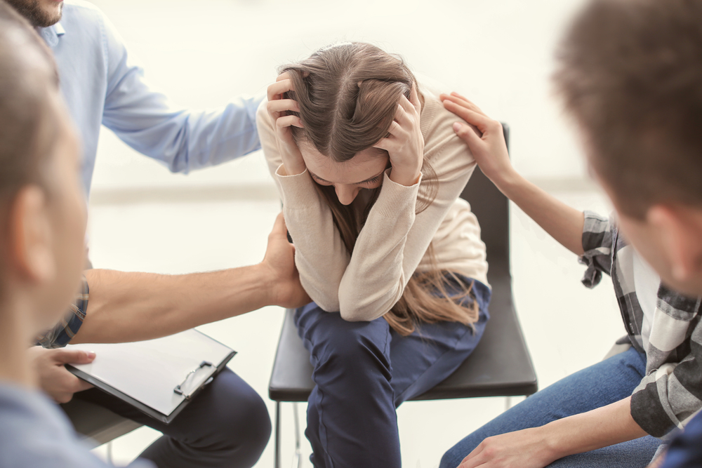A person receiving compassionate support in a counseling group