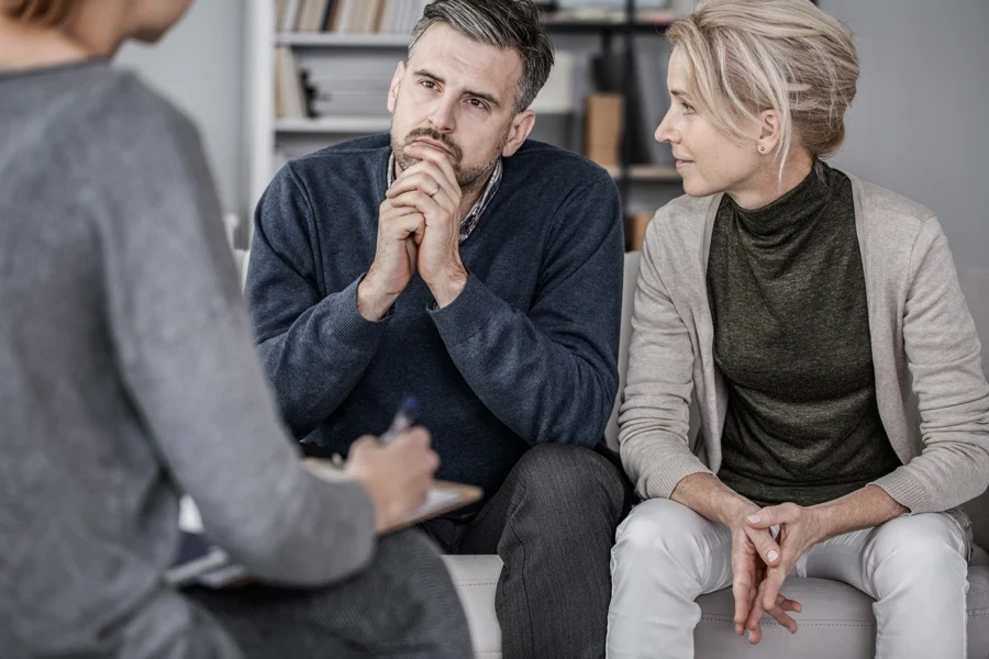 Military-connected couple speaking with a counselor